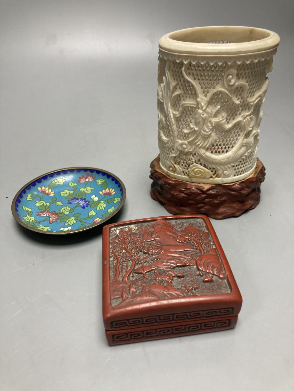 A Chinese cinnabar lacquer box, a carved ivory Chinese brush pot, 14cm and a cloisonne dish